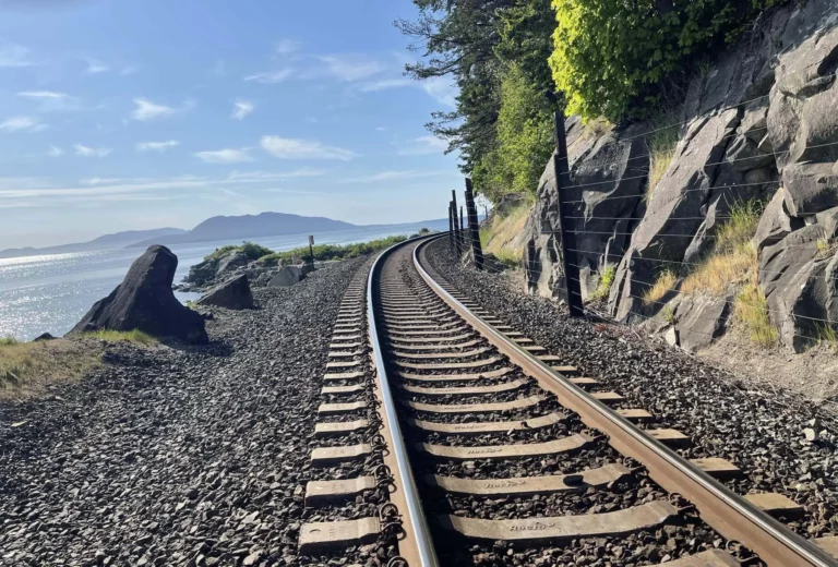 Walk on the beach side of the tracks for safety