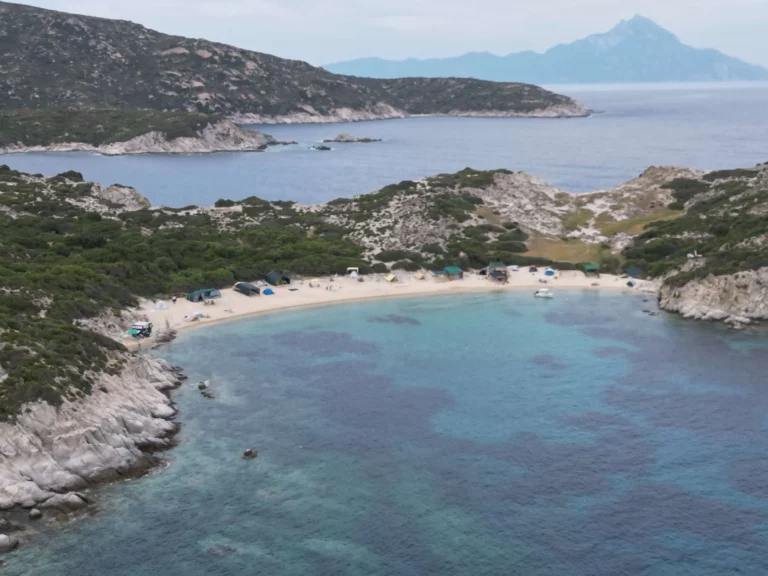 Kalamitsi town is to the left past the point, nude beach to the right