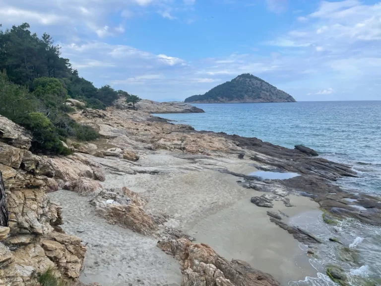 Small sandy beach in the nude section at Paradise Beach