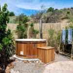 Garden area with wood fired sauna and hot tub at Finca Fabulosa Nudist Resort