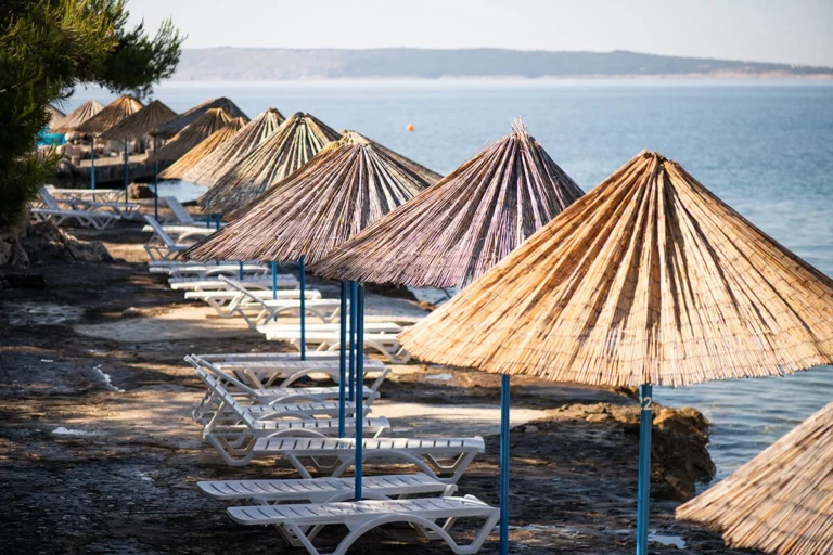 Plenty of shaded options at FKK Kandarola Beach