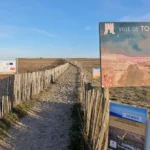 Entrance to nude beach with a map and info